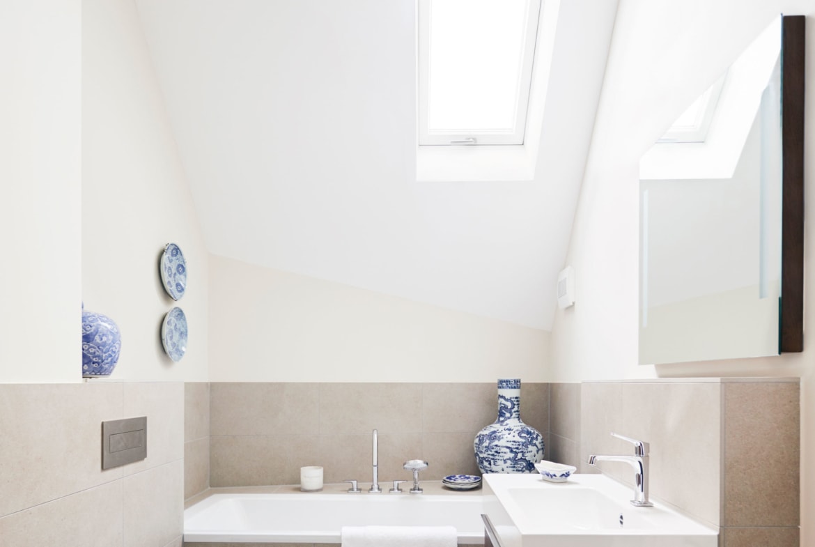 Badezimmer modern mit Badewanne unter Dachschräge - Inneneinrichtung Haus Design Ideen innen Baufritz Landhaus LLOYD WEBBER - HausbauDirekt.de