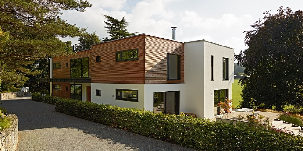 Luxus Fertighaus Villa modern mit Flachdach & Holz Putz Fassade im Bauhausstil bauen - Design Haus Villa Crichton von Baufritz - HausbauDirekt.de